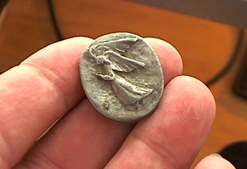I used to have many of these pewter angel coins.  This is the last one.